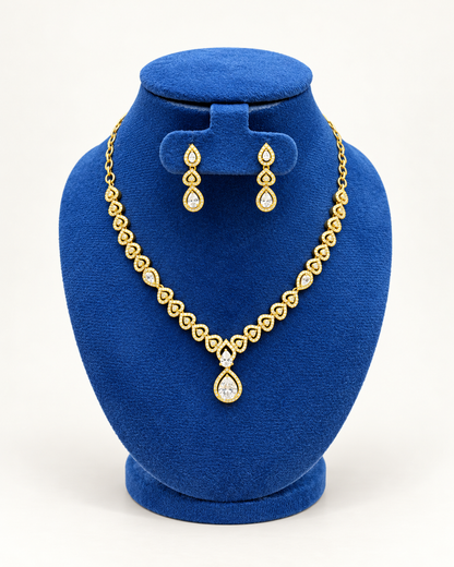 Kaveri heart garland teardrop necklace set with earrings in clear on a blue velvet display stand