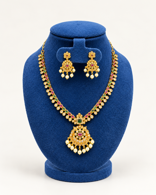 Kaveri long leaf stone pearl pendant necklace set with earrings in multicolor on a blue velvet display stand