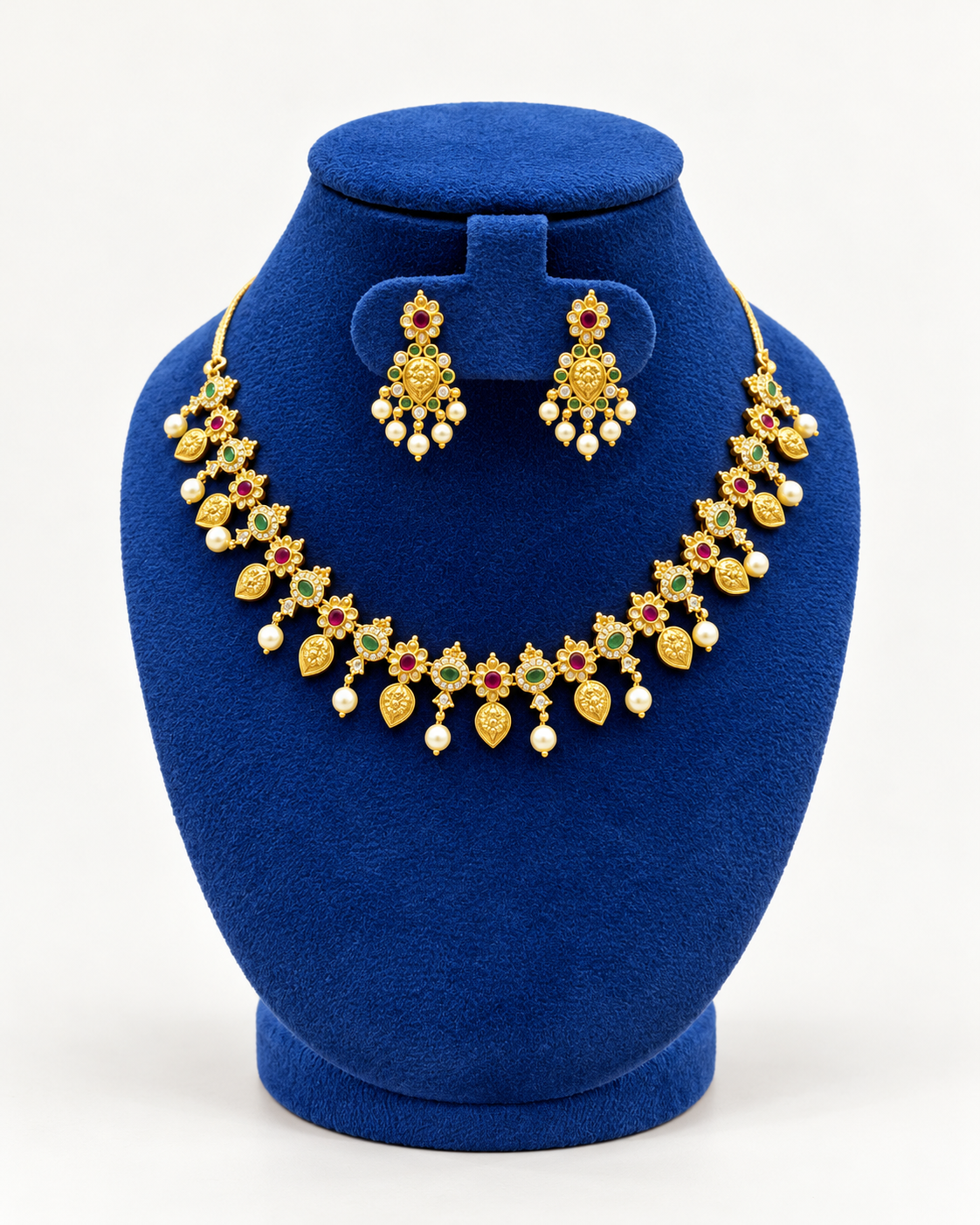 Kaveri floral mango pearl fringe necklace set with earrings in multicolor on a blue velvet display stand