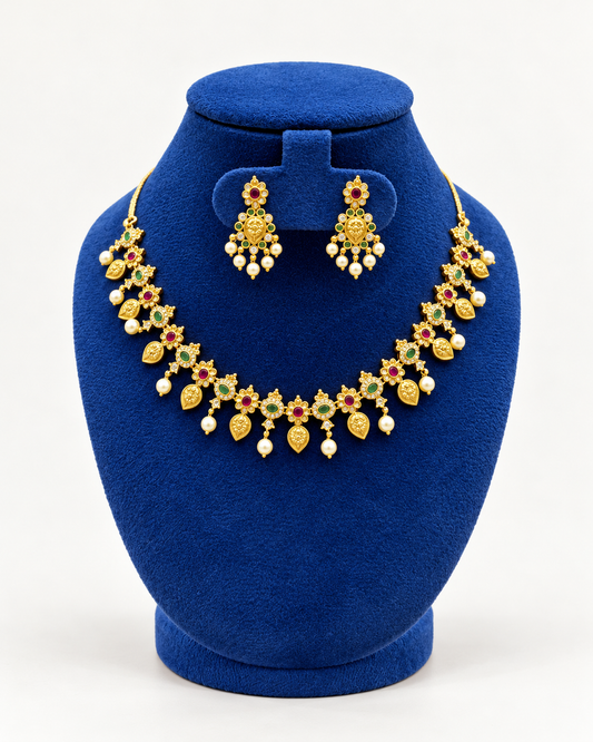 Kaveri floral mango pearl fringe necklace set with earrings in multicolor on a blue velvet display stand