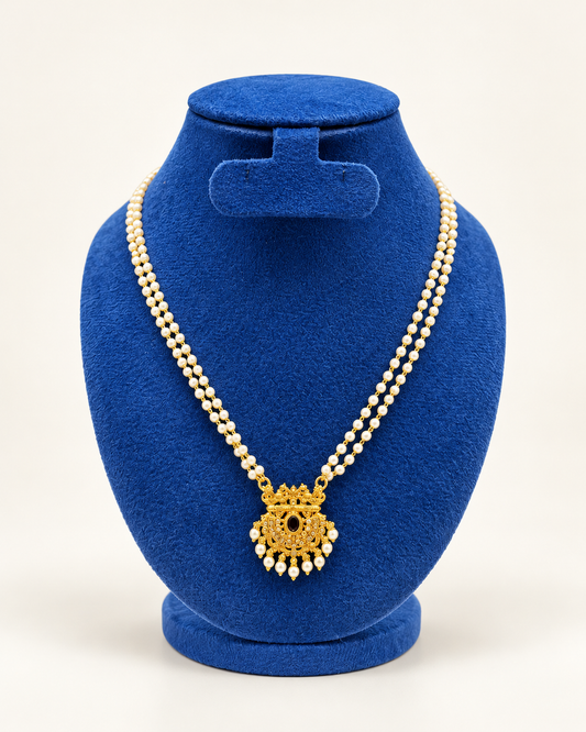 Kaveri double strand pearl temple pendant necklace in gold on a blue velvet display stand