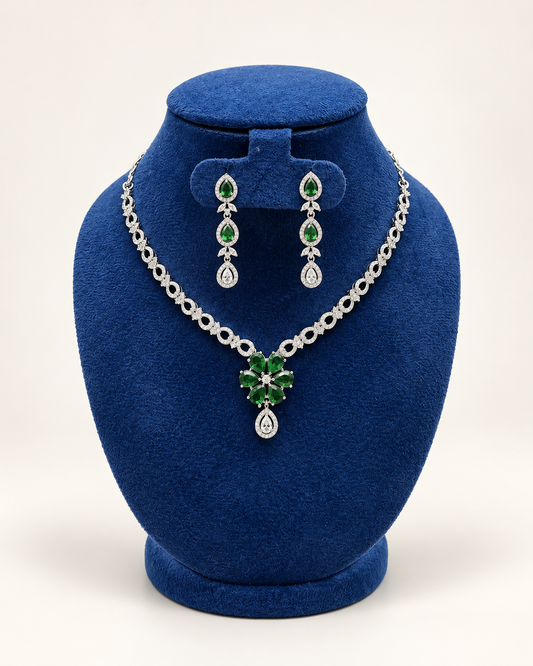 Kaveri floral centre necklace set with drop earrings in green on a blue velvet display stand