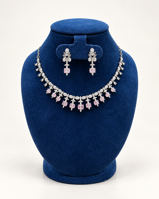 Kaveri floral fringe necklace set with earrings in pink on a blue velvet display stand